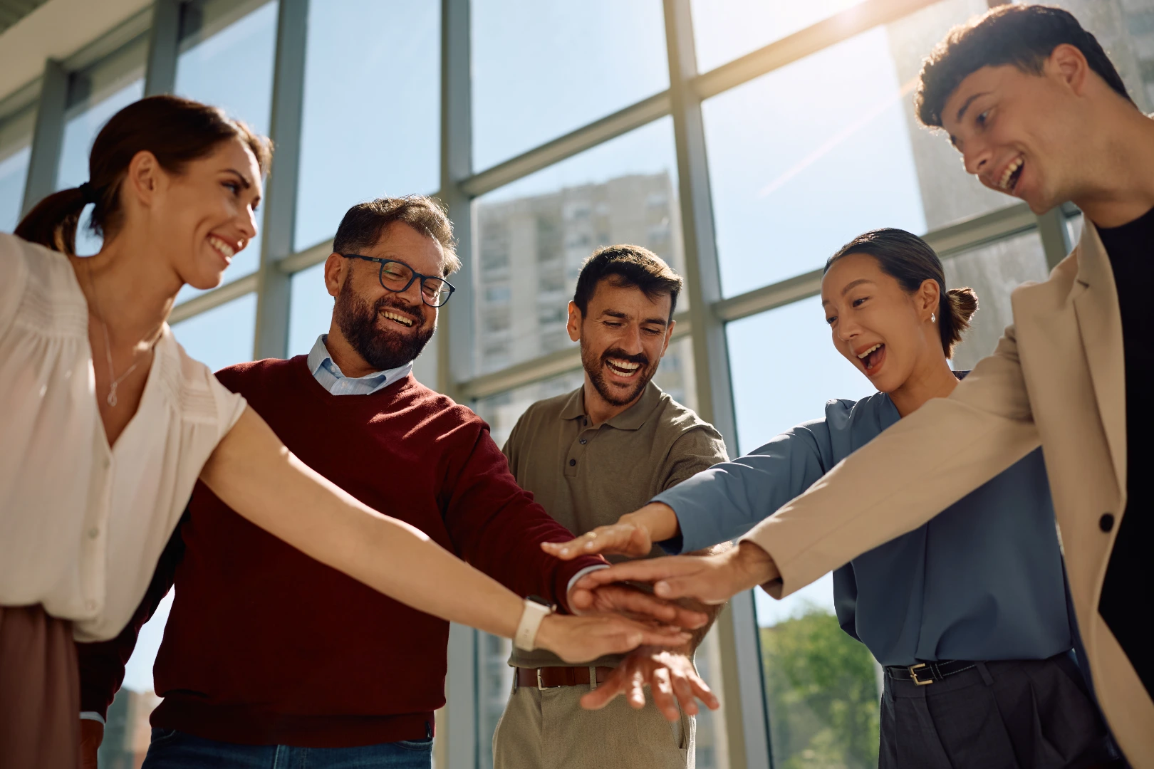 Coworkers joining hands in unity